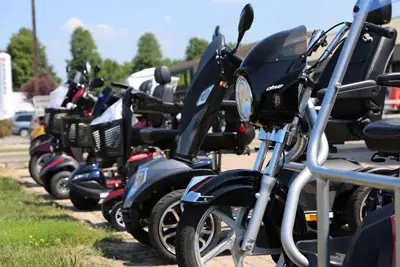A row of mobility scooters and power wheelchairs displayed outside the store.